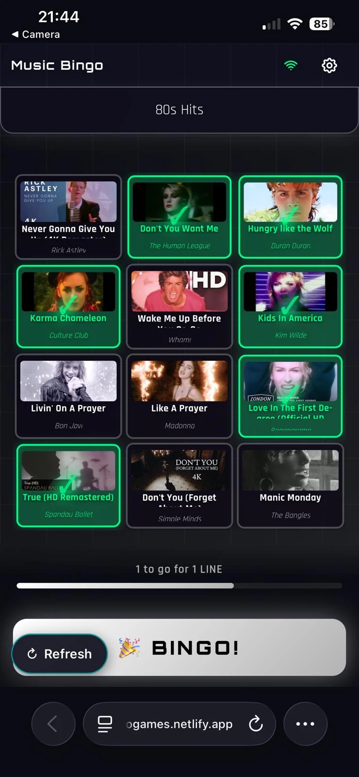 A player's Music Bingo card with recognised songs ticked off in green and one song to go for a line